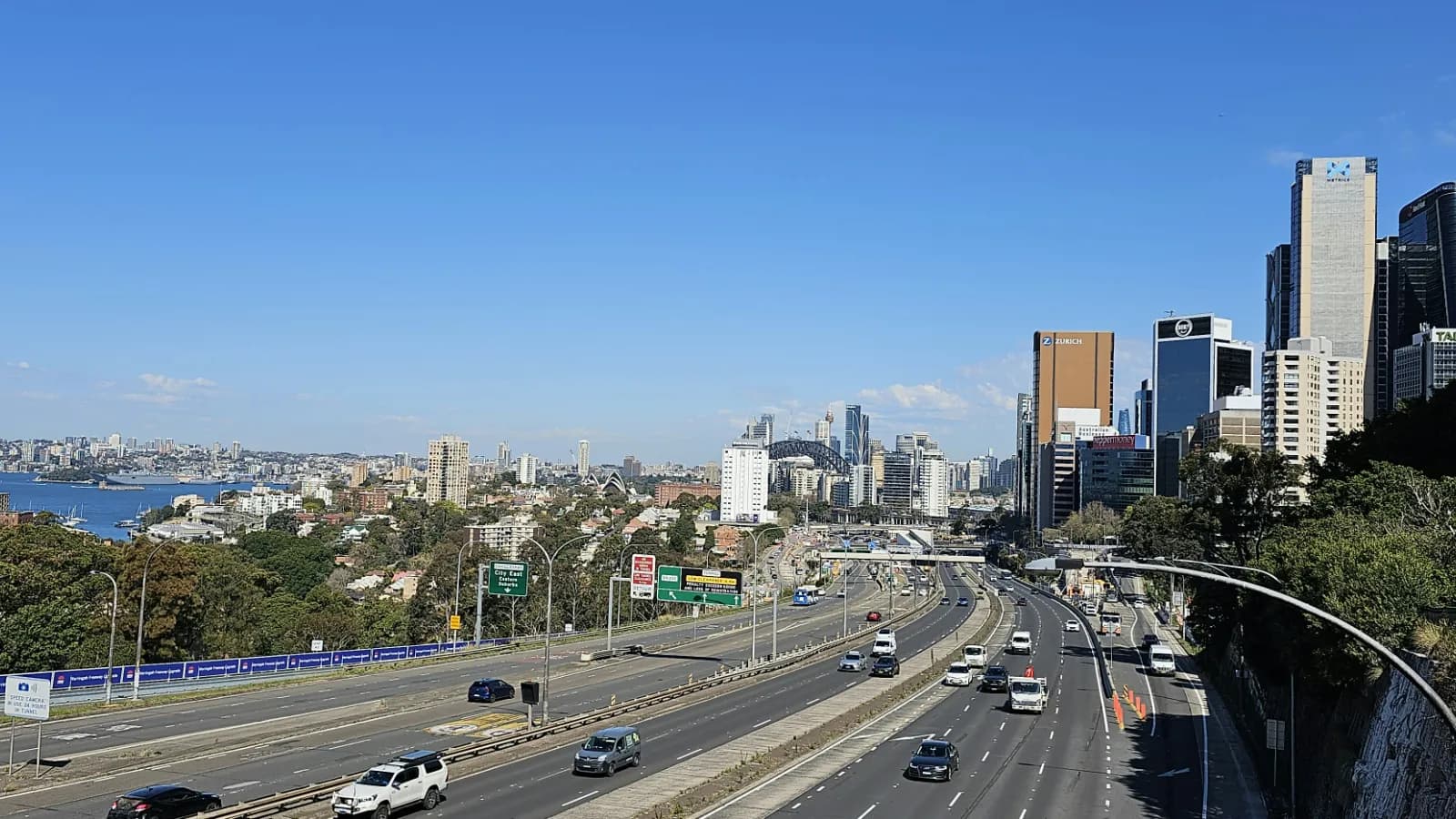 Wide daytime view of North Sydney, the Harbour Bridge and surrounding harbour suburbs